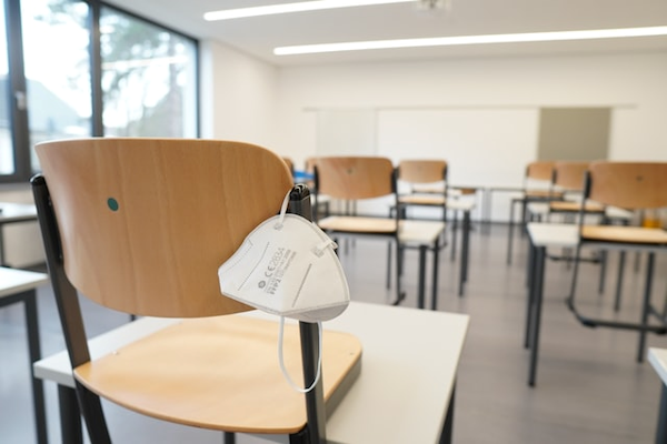 An empty classroom with corona mask.